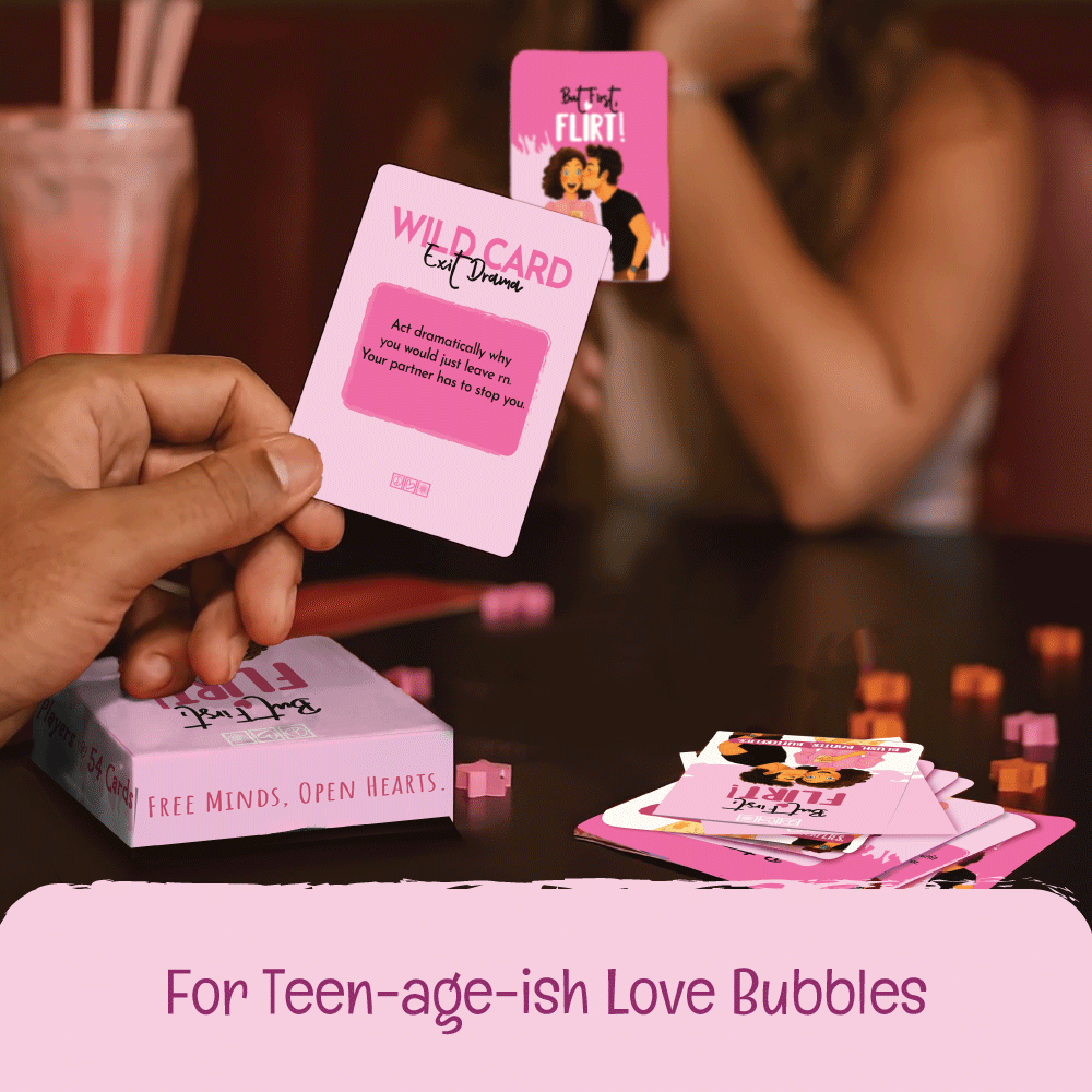 Person holding a card from a game with text 'WILD CARD' and 'For Teen-age-ish Love Bubbles' on a table.